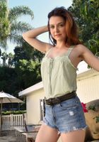 Emma squats down and sprays off the deck., Emma Evins (emm030) ATK Natural & Hairy: Emma Evins (Emma squats down and sprays off the deck.)